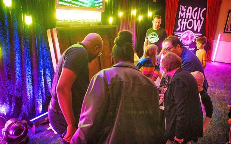 show attendees looking at illusionist props at the magic show at grande lakes orlando