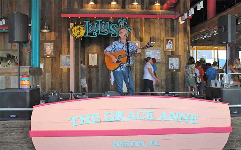 singer with guitar performing on outdoor stage at lulus destin