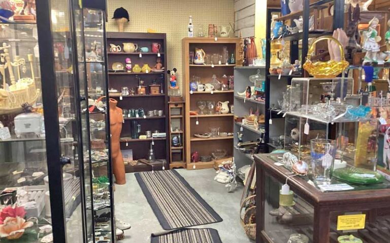 store area with several glass cases of figurines at defrance indoor flea market antiques collectables fort walton beach