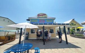 storefront with covered order window and customers lined up at boogies watersports destin