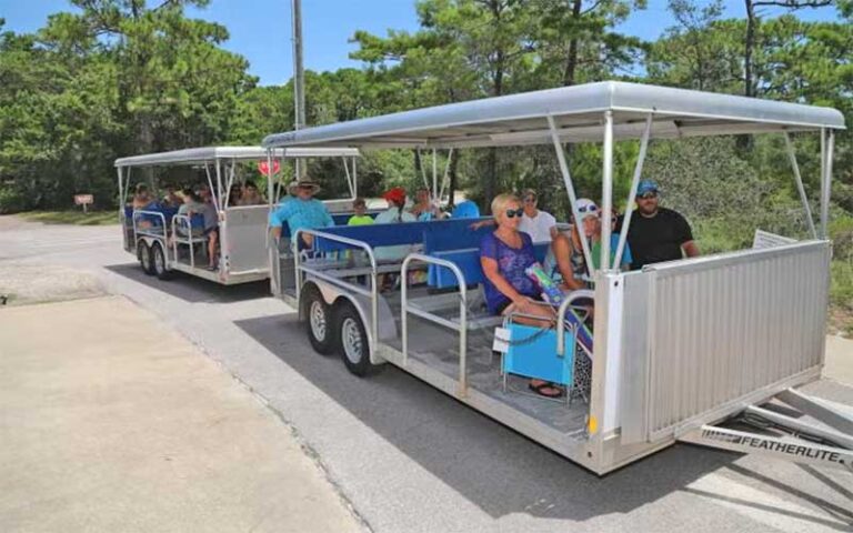 two trailer tram with beach goers at topsail hill preserve state park santa rosa beach