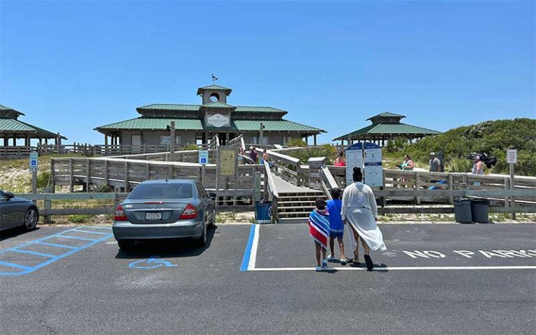 view from parking lot of pavilions with boardwalks over dunes at john beasley park fort walton beach
