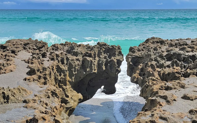 volcanic rock forms on beach with surf blowing rocks preserve jupiter