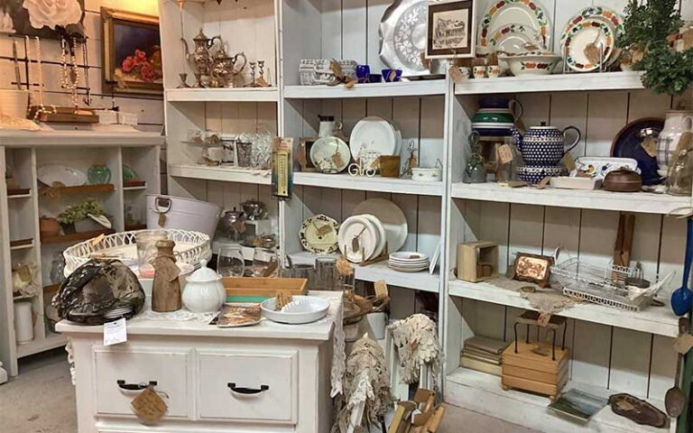 white shelves and desk with mid century decor items at defrance indoor flea market antiques collectables fort walton beach