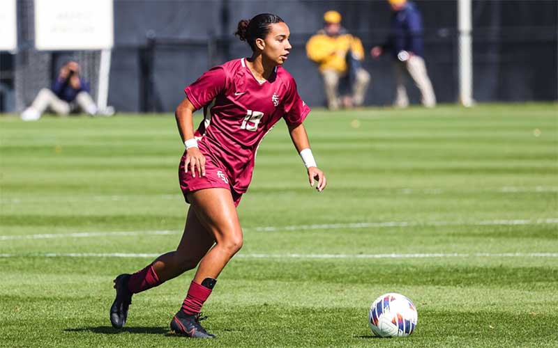 woman player about to kick soccer ball on field florida state college team