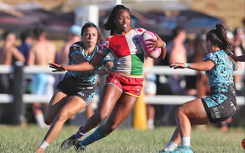 women rugby players dodging on field at bradenton island tournament