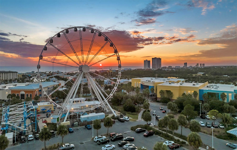 aerial view of park with observation wheel and sunset sky at skywheel pier park panama city beach