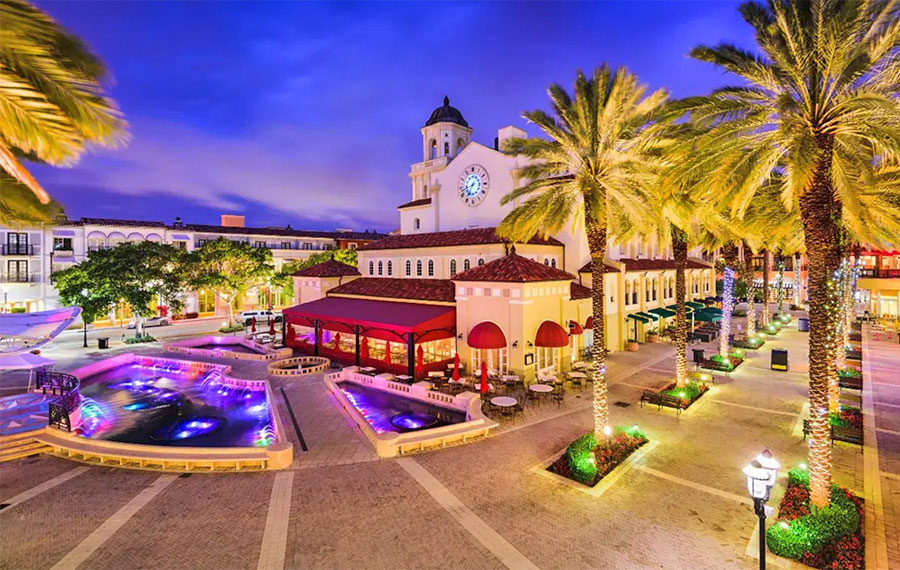 aerial view of shopping plaza with clock and fountains at night cityplace west palm beach