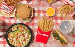 aerial view of spread with burger fries dog and salad at portillos orlando tampa
