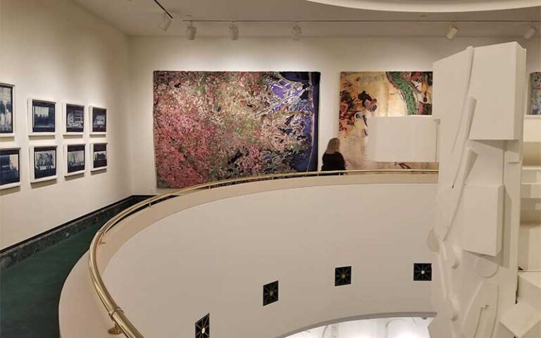 circular stairwell balcony with hanging art and sculpture the baker museum artis naples