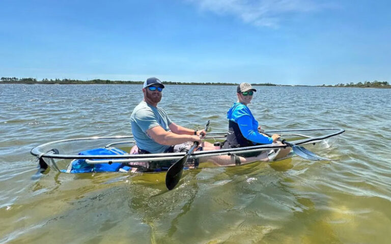 couple in clear kayak on green water at get up and go kayaking destin