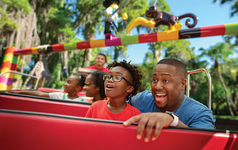 dad and son on pirate river adventure ride at legoland florida resort