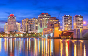 downtown skyline view across bay colorful high rise buildings with reflection and bridge west palm beach