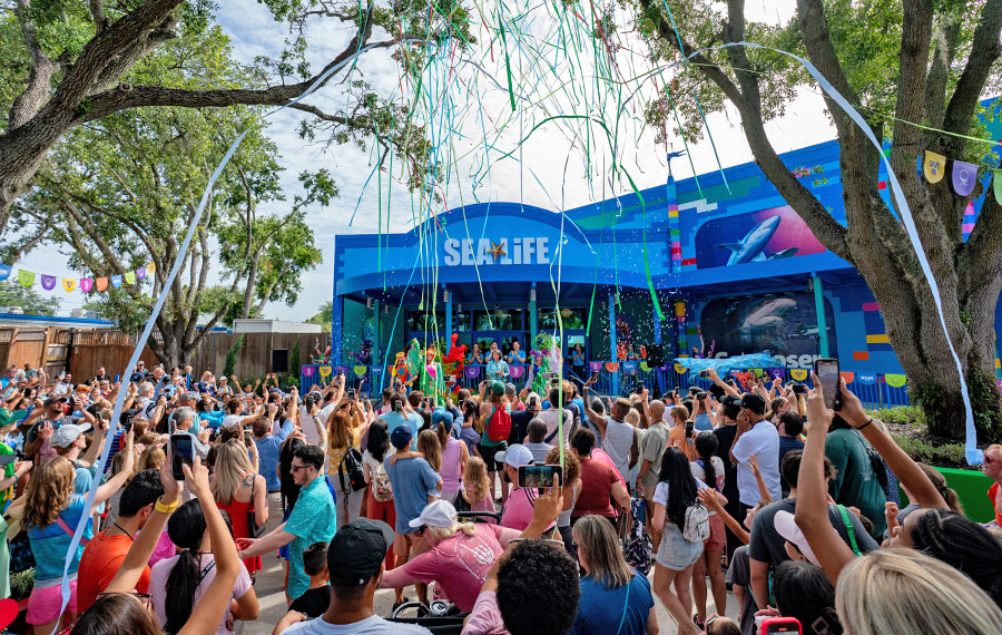 exterior of attraction with crowd and streamers at grand opening of at sea life florida at legoland
