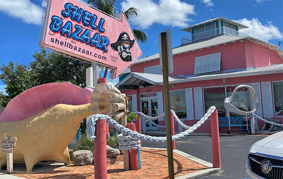 exterior roadside shop with neon sign and giant conch at shell bazaar port st lucie