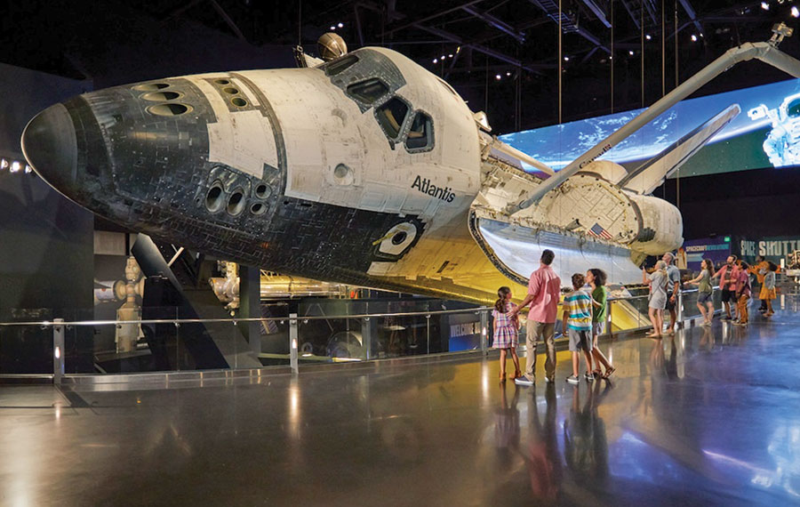family admiring space shuttle at kennedy space center visitor complex