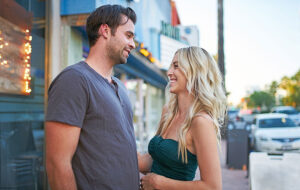flirty romantic couple on date walking on sidewalk downtown district
