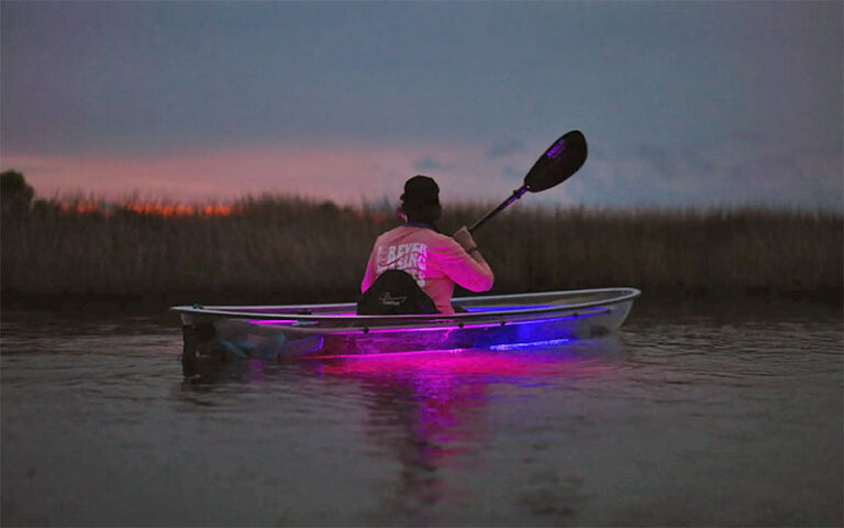 kayaker on river at night with illumination at get up and go kayaking destin