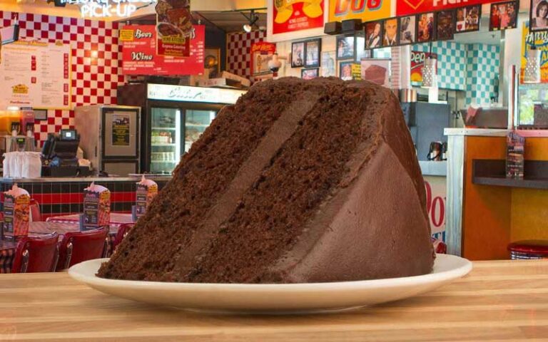 large slice of chocolate cake with cafe background at portillos orlando tampa