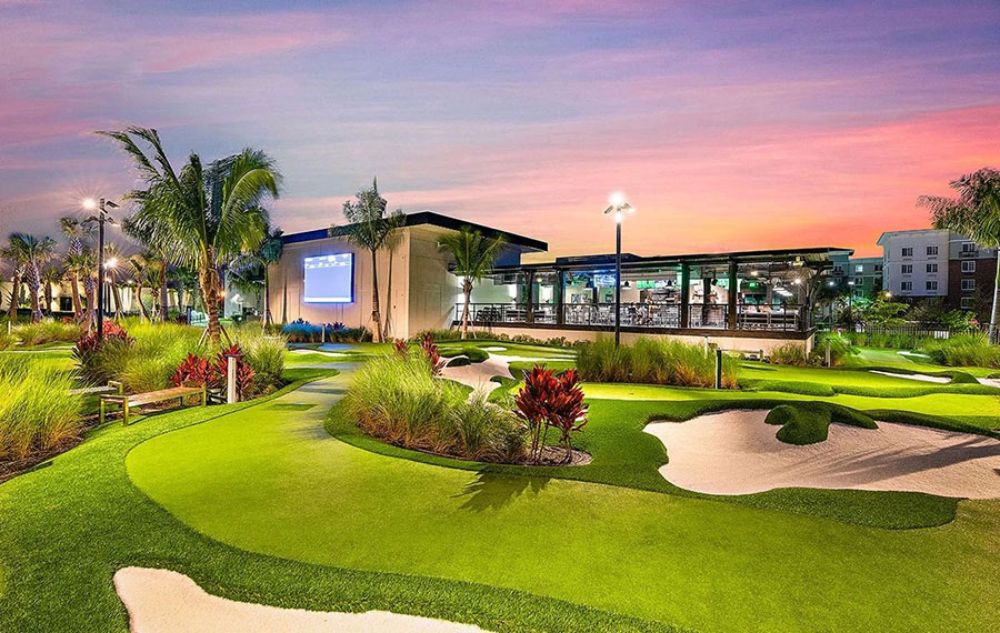 restaurant and mini golf exterior with sunset sky at popstroke port st lucie