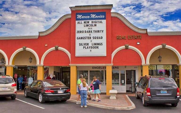 theater exterior with family and marquee sign at marco movies marco island