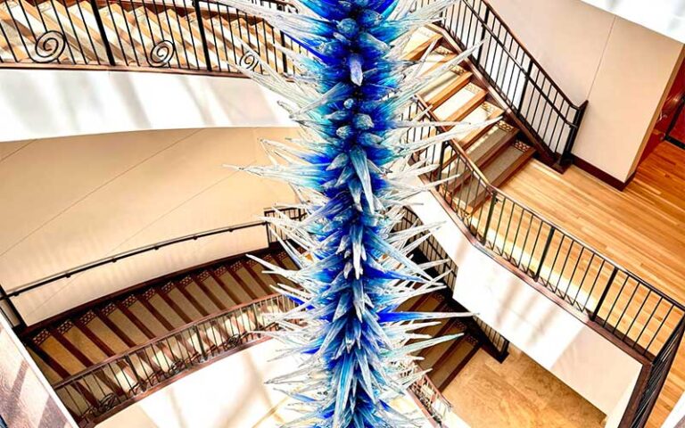 view down stairwell center with blue blown glass sculpture the baker museum artis naples