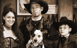 family with dog dressed in western wear portrait at old time photos at dezerland park orlando