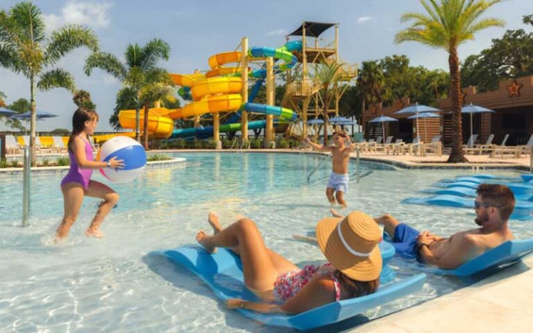 family relaxing with kids playing in water park at river country water park river ranch