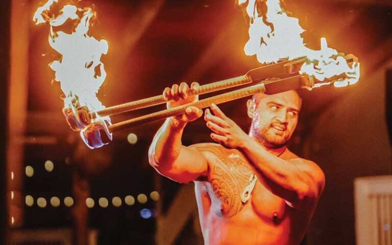 fire dancer with torches aflame at coco key luau dinner show orlando