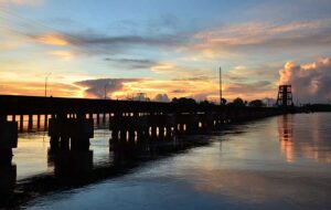 railway bridge with blue and gold sunset sky stuart florida