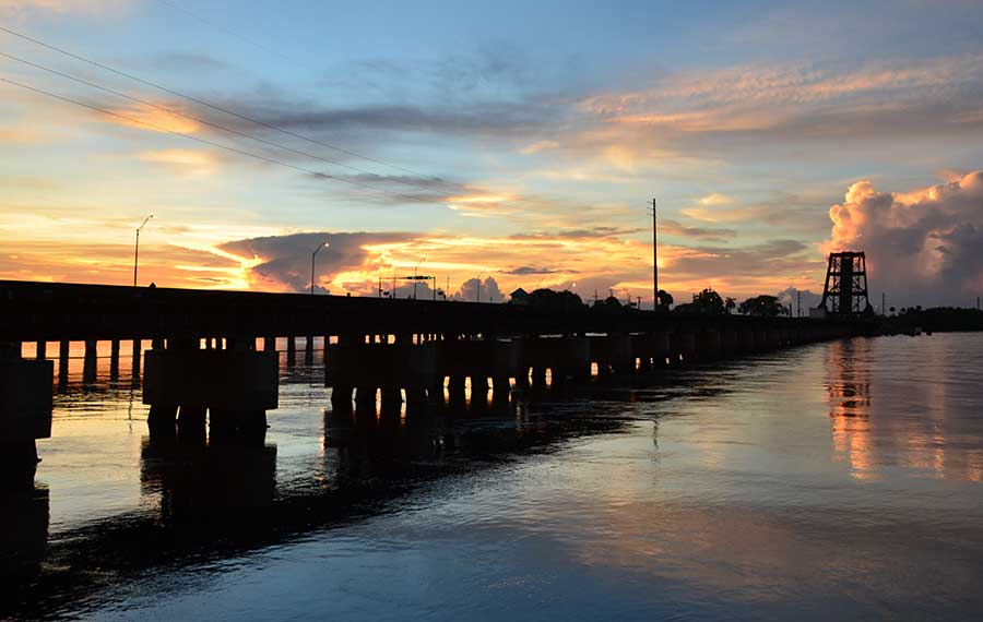 railway bridge with blue and gold sunset sky stuart florida