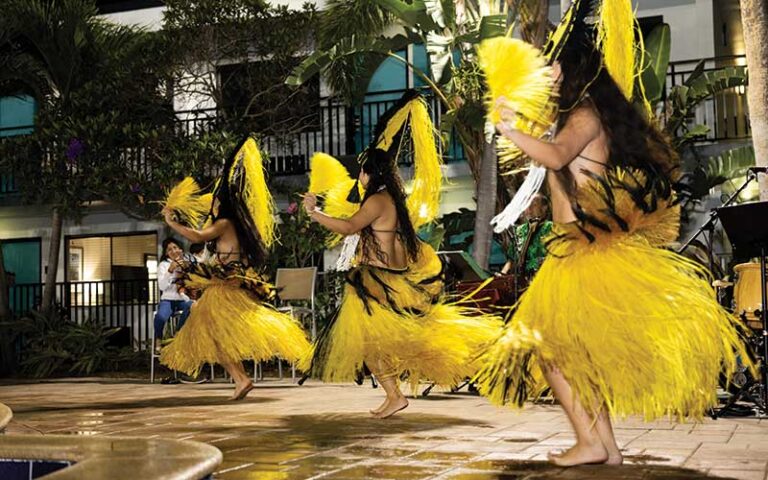 row of yellow skirted hula dancers at coco key luau dinner show orlando