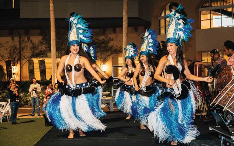 rows of hula dancers in blue costume at coco key luau dinner show orlando