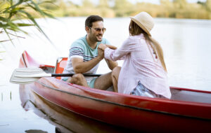 closeup of couple holding hands while canoeing on florida waterway