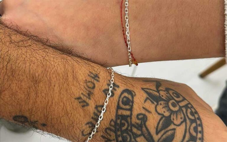 couple with matching bracelets at permanent jewelry miami orlando