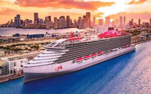 cruise ship docked with miami skyline virgin voyages port miami