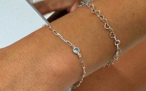 ladies wrist with two silver chains at permanent jewelry orlando miami