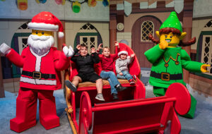 lego santa and elf characters with kids in sleigh legoland florida resort