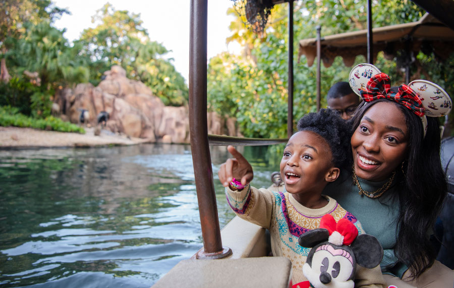 mom and kid on boat ride river jungle cruise at disney world