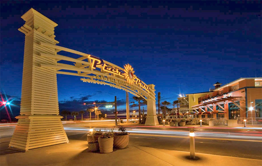 gated entrance above street in shopping district at night pier park panama city beach