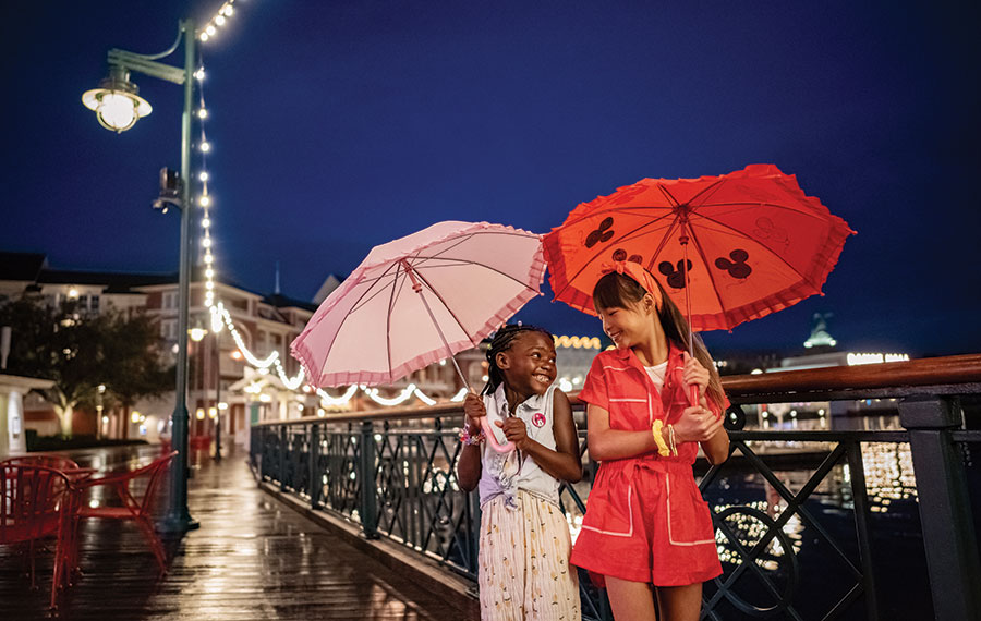 girls with disney umbrellas on rainy boardwalk disney world florida