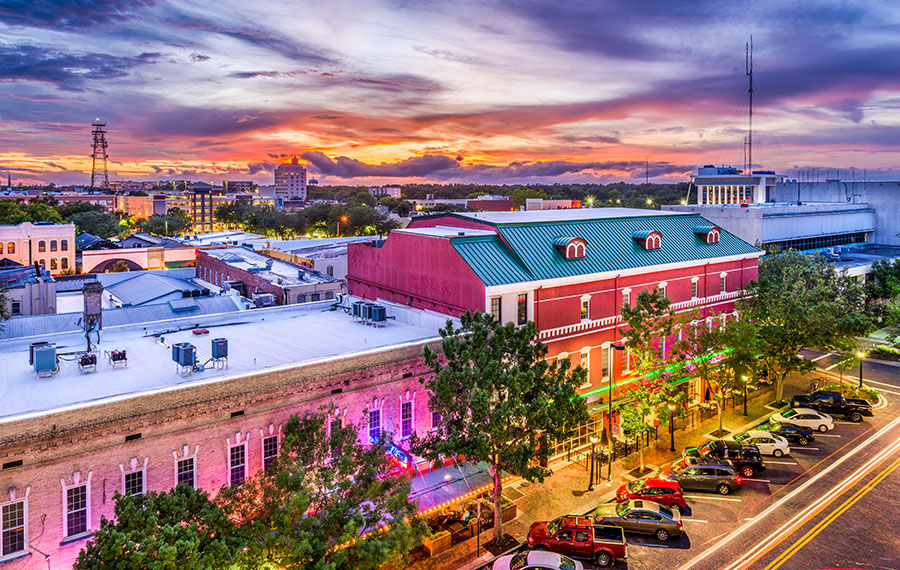 aerial skyline of downtown with colorful buildings and sunset sky over gainesville