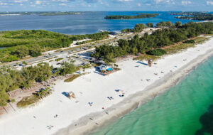 aerial view of narrow island with beaches and green water anna maria island