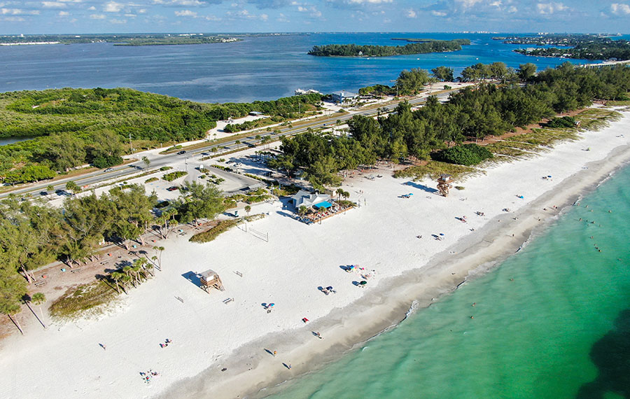 aerial view of narrow island with beaches and green water anna maria island