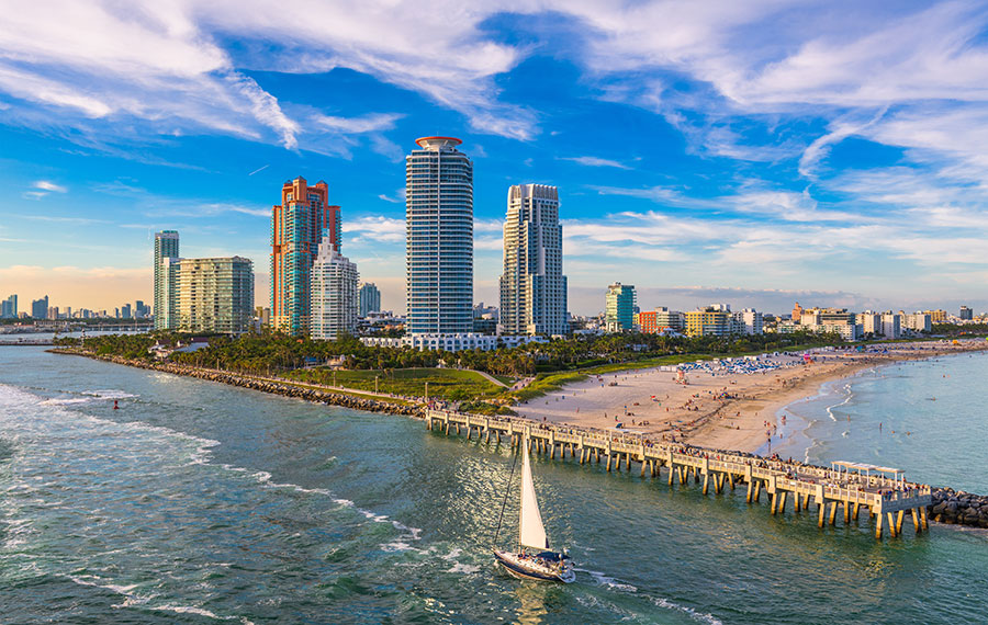 aerial view of high rises jetty and sailboat at south beach miami