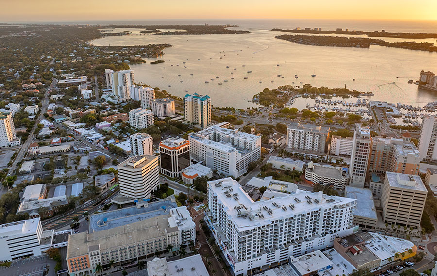 aerial view of sarasota downtown with sunset sky and bay