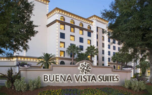 high rise hotel with sign in front at buena vista suites orlando
