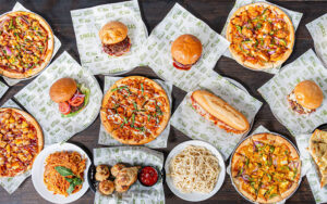 spread of pizza, burgers and salads at singas famous pizza orlando