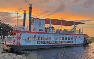 red and white paddlewheel boat with sunset sky at old florida riverboat company st cloud