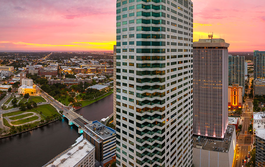 downtown tampa skyline with river and sunset sky